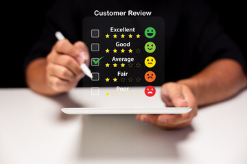 A person reviews a service on a tablet, selecting ratings from excellent to poor, showcasing...