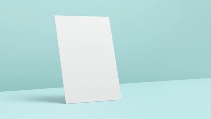 Naklejka premium a single blank white sheet standing at an angle against pastel cyan background