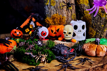 fun Halloween party in a dark forest in a glade with a skull, ghost, spiders, black hands,...