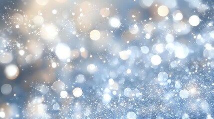 Magical winter bokeh background with sparkling glitter and blurred lights in silver and gold tones, creating dreamy festive atmosphere for holiday designs.