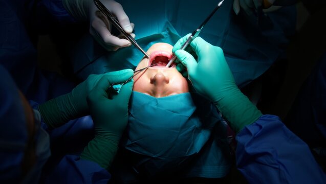 Patient Undergoing Surgical Procedure with Medical Professionals in Operating Room