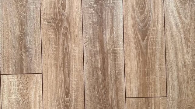 Wooden natural laminate on floor. Laying laminate flooring. Laminate laying scheme. Top view