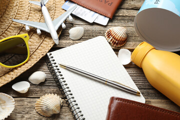 Time for summer vacation. Stationery, passport, flight tickets, toy plane, world map and beach...