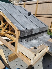 New roof construction with traditional led roofing and exposed wooden framing, showing building progress