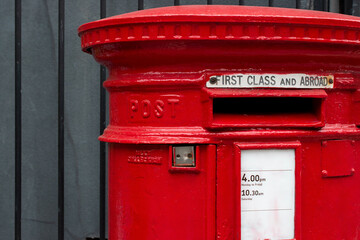 Red british post box on street, concept of communication, tradition, postal service