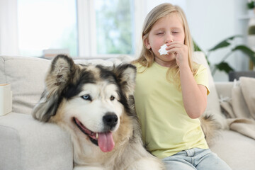 Girl suffering from allergy with her dog at home