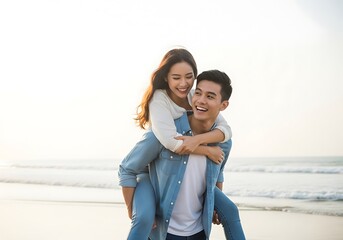 Happy couple enjoying a piggyback ride on the beach