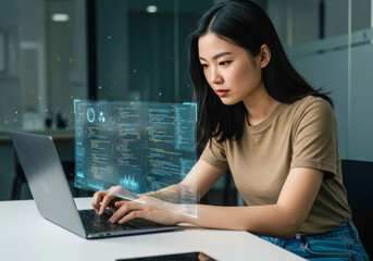 Young Asian woman engaging with futuristic data and code visualizations while intently typing on a laptop in a modern office.