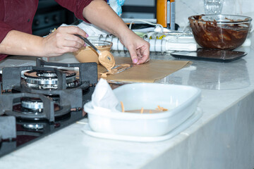 Fototapeta premium Chef making a delicate decoration with caramel chocolate.