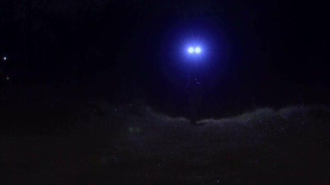 Fugitive Running from Drone Chasing Him in a Field at Night
