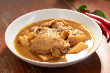 Thai tradition food : Massaman Curry is popular Thai food. Chicken curry with coconut milk, chili, and spicy herbs. Served with steam jasmine rice and fried egg. Isolated on white background. Close up