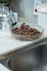 Chopped milk chocolate waiting to be melted_vertical.