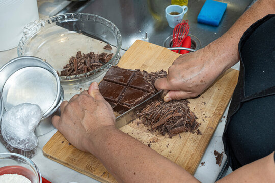 Pastry chef chopping chocolate to make a pie filling_top view.