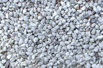 Background of small white and gray stones forming a pattern. Texture of stones. Nature concept