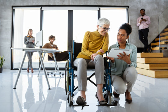 Multiracial coworkers analyzing charts and working together showing teamwork diversity and inclusion