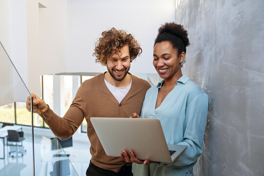 Team collaboration and digital transformation with colleagues sharing ideas at a laptop in office