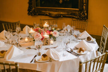 Elegant table setting with flowers and candles for a special occasion in a beautifully decorated...