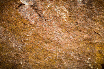 Beautiful rock surface with rough texture and reddish-brown coloration. Streaks and variations create depth and interest. Background with copy space.