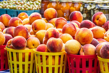 Baskets of fresh peaches in an open air market