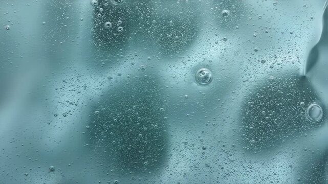 Transparent gel texture with bubbles moves and undulates. Moisturizing cosmetic refreshing face care product. Concept beauty spa serum product