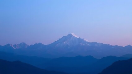 Majestic mountain range during blue hour, with a soft gradient of twilight colors.