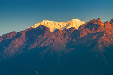 Beautiful first light from sunrise on Mount Kabru, part of ridge that extends south from third...