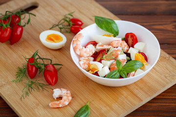 Summer salad with seafood and fresh vegetables in a bowl