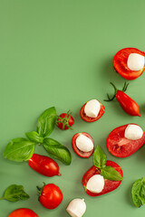 studio serving of caprese ingredients on green surface