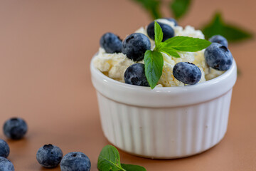 Healthy breakfast cottage cheese with blueberries and fresh mint