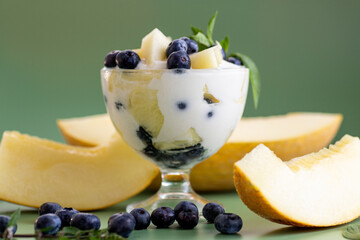 Elegant dessert in a glass yogurt melon blueberries and mint