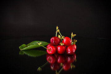 delicious red cherries on a black background