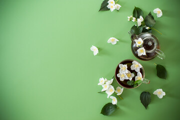 Green tea with jasmine in a glass teapot from above