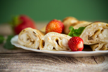 Homemade pancakes with cottage cheese filling and berries