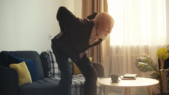 Elderly male suffering sharp lower back pain, muscle inflammation, radiculitis