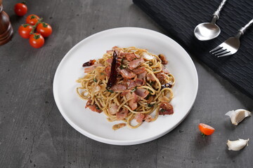 Place the spaghetti on a plate with a placemat and the tomato and garlic seasoning mixture on the...