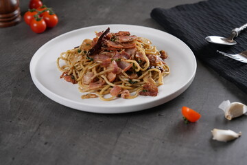Place the spaghetti on a plate with a placemat and the tomato and garlic seasoning mixture on the...