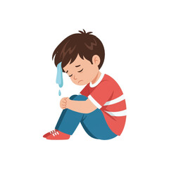 Sad child sitting alone on the floor, feeling upset with a tear rolling down his face