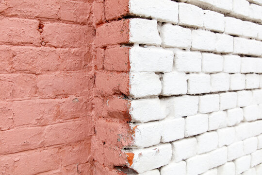 A white and red brick wall with a white line painted on it