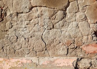 A wall with a brick border and a large crack in it