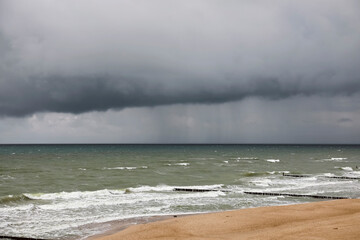 Dark, thick clouds cover the sky above the Baltic Sea, as seen from Mielno, a Polish seaside town