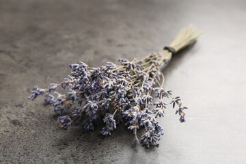 Bunch of aromatic lavender flowers on grey table, closeup
