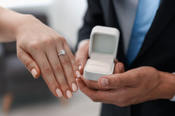 Making proposal. Woman with engagement ring and her fiance indoors, closeup