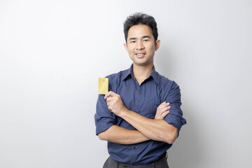 A man stands holding a cell phone, laptop, and credit cards. He is smiling happily and making various gestures for the camera.

