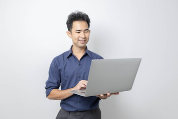A man stands holding a cell phone, laptop, and credit cards. He is smiling happily and making various gestures for the camera.

