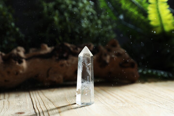 Aura. Beautiful crystal on wooden surface outdoors
