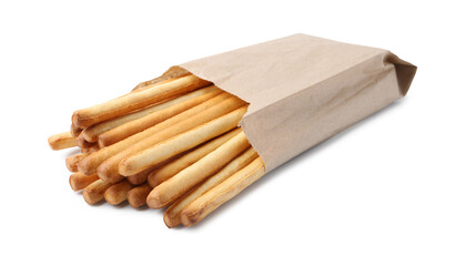 Delicious grissini sticks in paper bag isolated on white