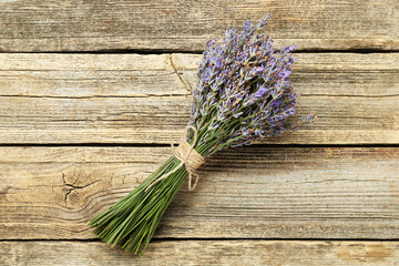 Bunch of beautiful lavender flowers on wooden table, top view