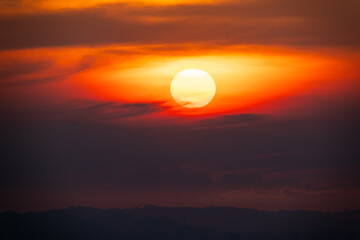 Radiant sunset with the sun emerging from clouds in Pinglin, Taiwan, on May 8, 2025, displaying pink and orange hues.