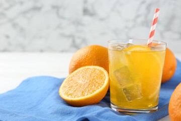 Refreshing soda water with orange slice in glass and fresh fruits on table, closeup. Space for text