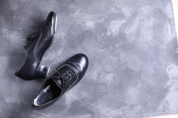 Pair of shoes for tap dance on grey surface, top view. Space for text